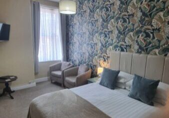 Bright double bedroom with floral feature wall